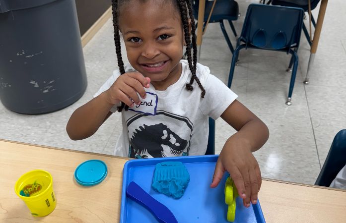  Pre K student play and all smiles.